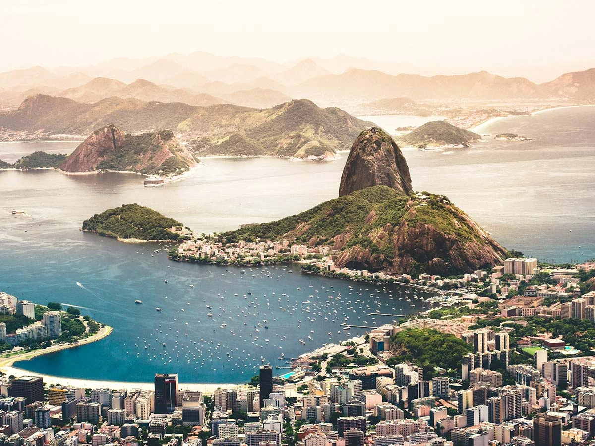 An iconic aerial view of Sugarloaf Mountain and Guanabara Bay in Rio de Janeiro, a top destination for expats in Brazil.