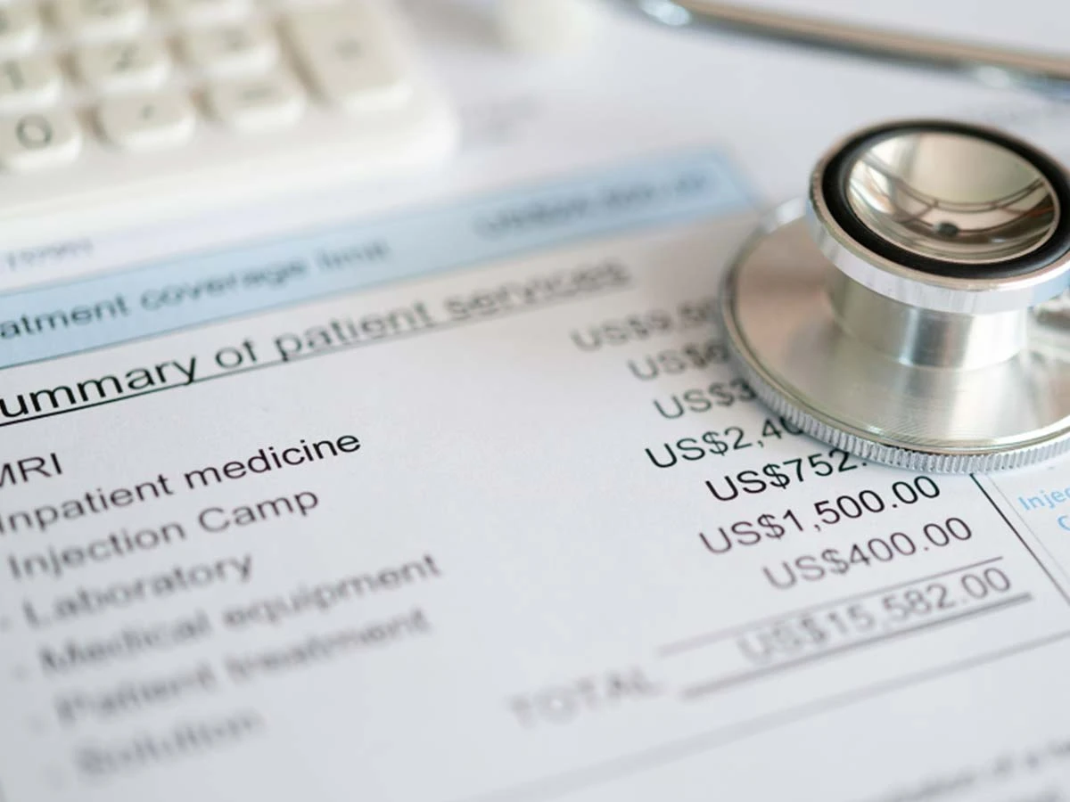 A stethoscope resting on a medical bill, illustrating the comparison between high US healthcare costs and affordable Brazilian private clinics.